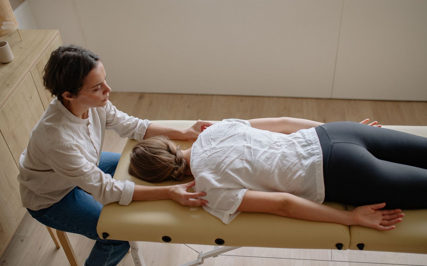 A hands-on manual therapy adjustment in a calm clinic setting