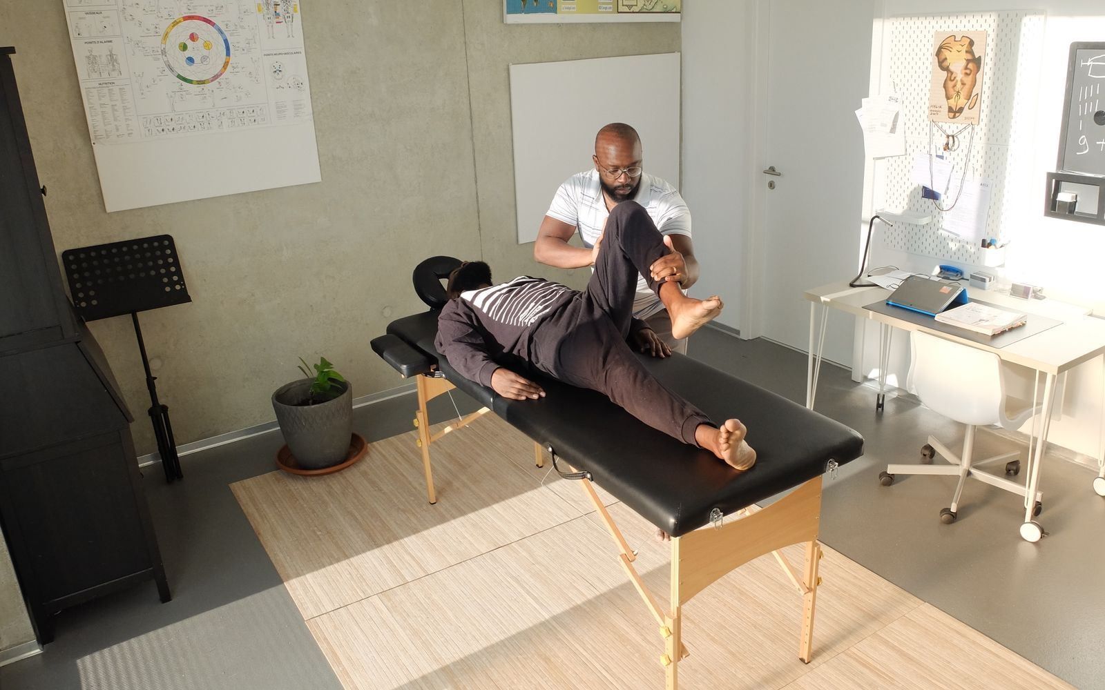 A hands-on manual therapy session in a clinic treatment room